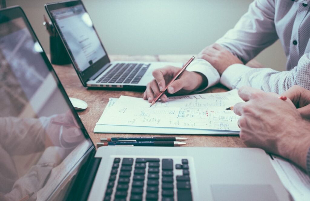 A fractional CFO and business owner reviewing financial figures together